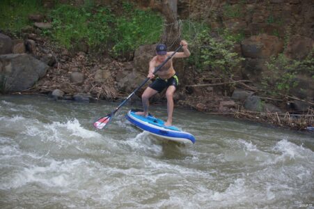 SUP rider paddling whitewater on River Jordan