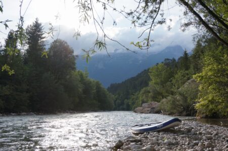 Soca River in Slovenia near Bovec Paddleboard under mountains in clouds