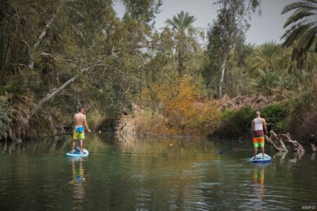 Travelling around Israel Two guys paddling on SUP in Israel