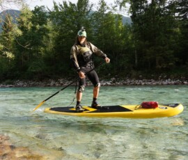 Rider on a yellow SUP on Soca River with gopro on