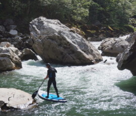 Big rock and a rider on a SUP
