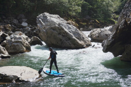 Big rock and a rider on a SUP