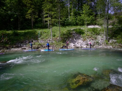 Crystal clear Alp river and Stand Up Paddleboarding