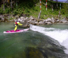 Girl overcoming a rapid in Austria on Tambo SUP