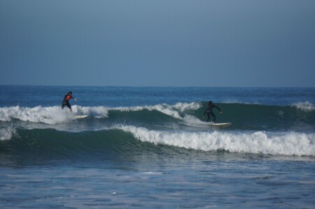 Surfing - two surfers on one wave