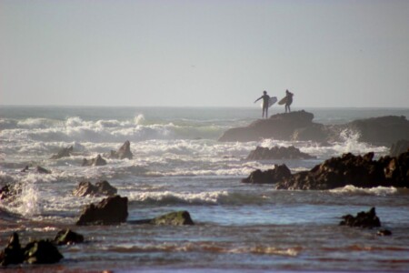 Two surfers on a cliff